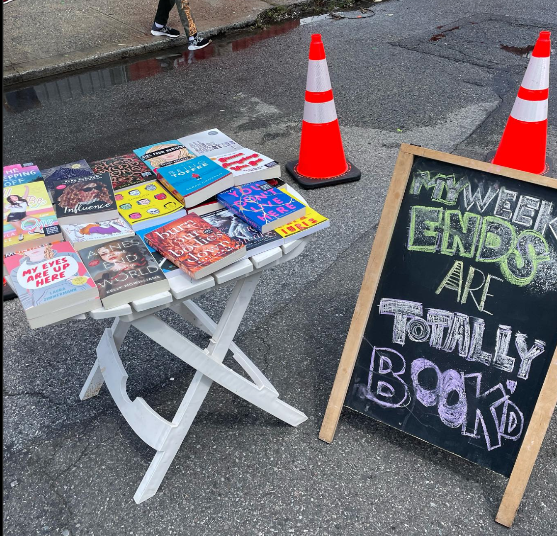 A crowd of young children gathers around House of SpeakEasy's Bookmobile