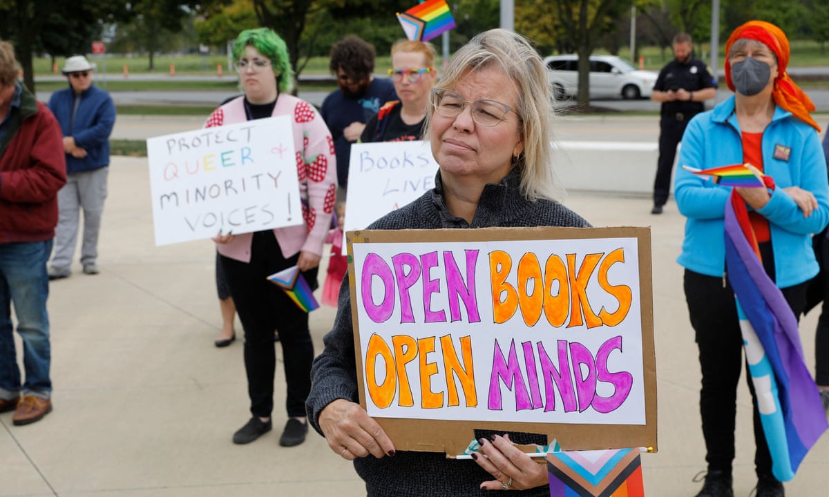 People holding signs supporting open books and open minds