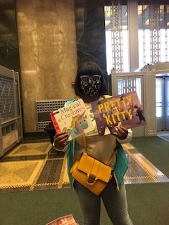 woman holding picture books